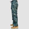 Green camo techwear pants with cargo pockets, utility straps, chain details, and relaxed streetwear styling