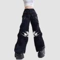Mens tribal gothic cargo pants in black featuring white tribal graphic artwork, utility cargo pockets, wide-leg fit, and metal ring details