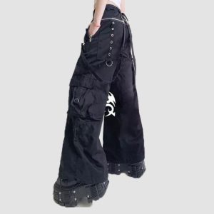 Mens Tribal Gothic Cargo Pants Mens tribal gothic cargo pants in black featuring white tribal graphic artwork, utility cargo pockets, wide-leg fit, and metal ring details
