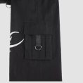 Mens tribal gothic cargo pants in black featuring white tribal graphic artwork, utility cargo pockets, wide-leg fit, and metal ring details