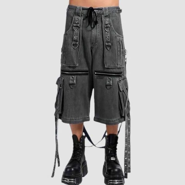 Wide leg cargo jeans in black wash denim with utility pockets, adjustable straps, and relaxed streetwear styling